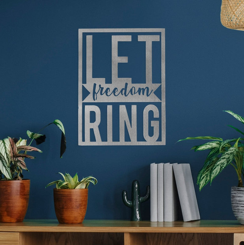 Metal rectangle sign saying let freedom ring, hanging on wall above shelf.