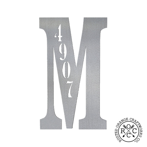 Metal letter with house number inscribed, against white background.