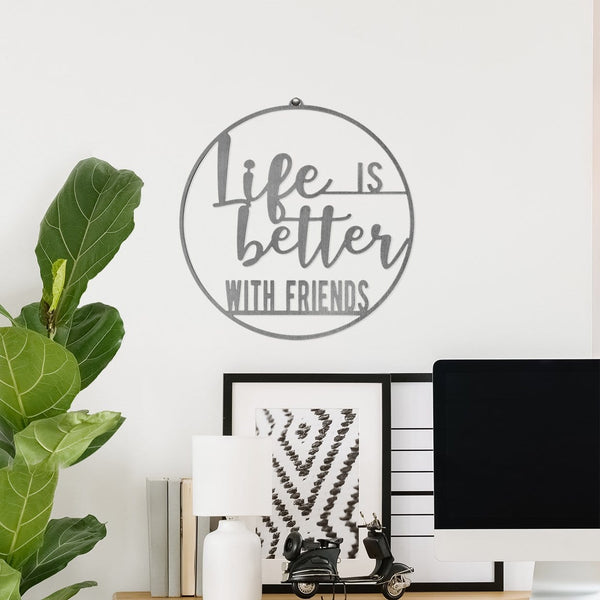 Round metal sign saying life is better with friends, hanging on wall above shelf.