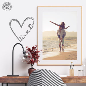 Love is all around sign next to picture of happy couple