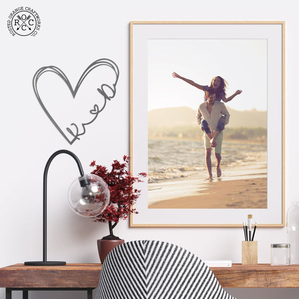 Love is all around sign next to picture of happy couple