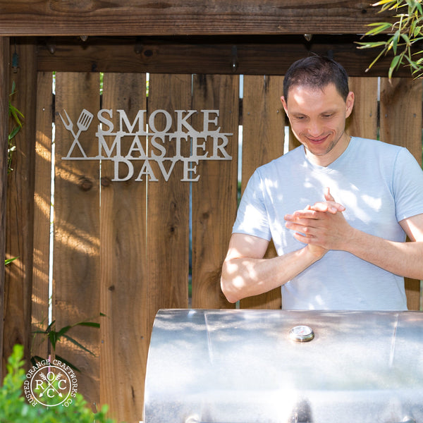 Smoke master plaque on fence behind man with smoker