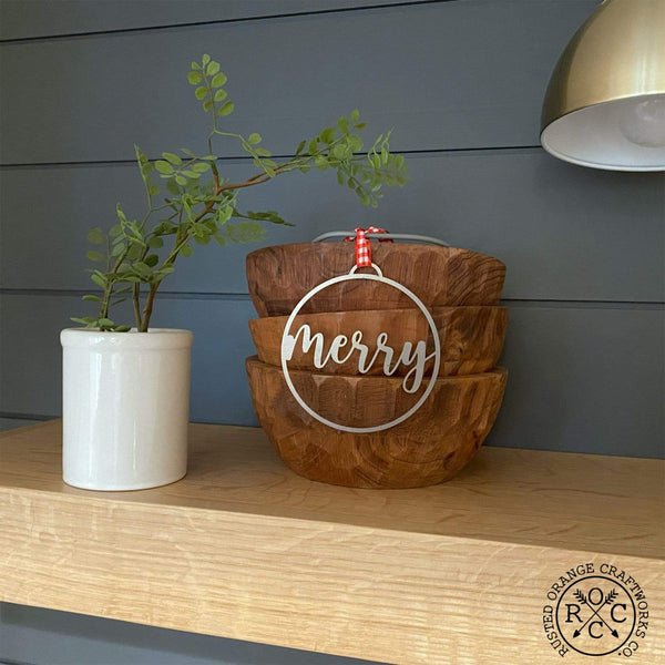 merry ornament on christmas tree