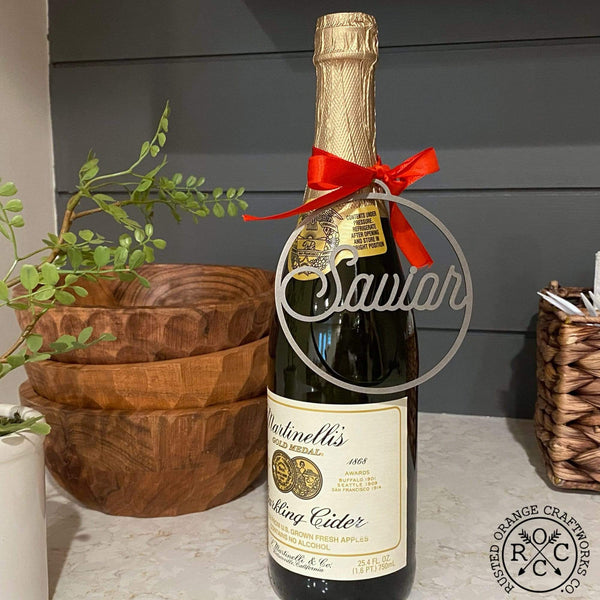 savior ornament hanging on sparkling cider bottle