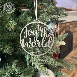 joy to the world ornament hanging on Christmas tree
