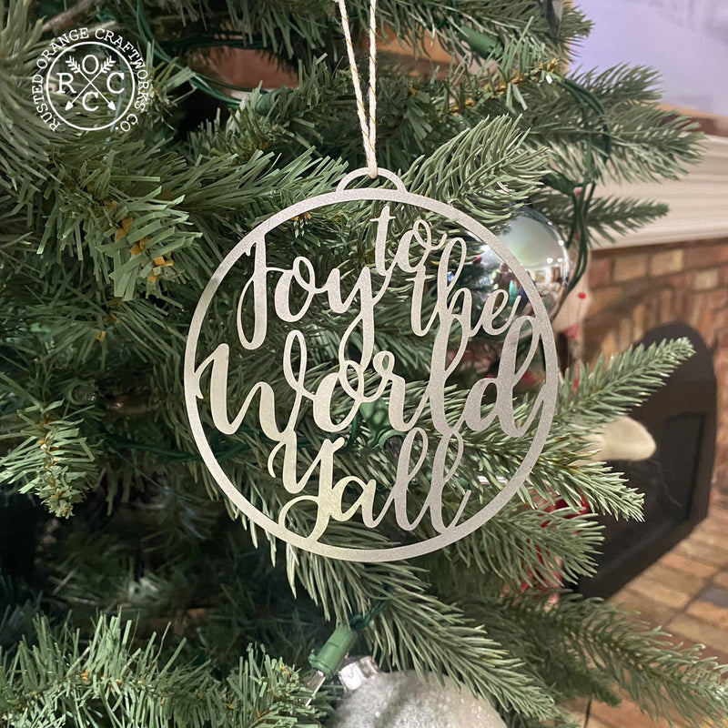joy to the world ornament hanging on christmas tree