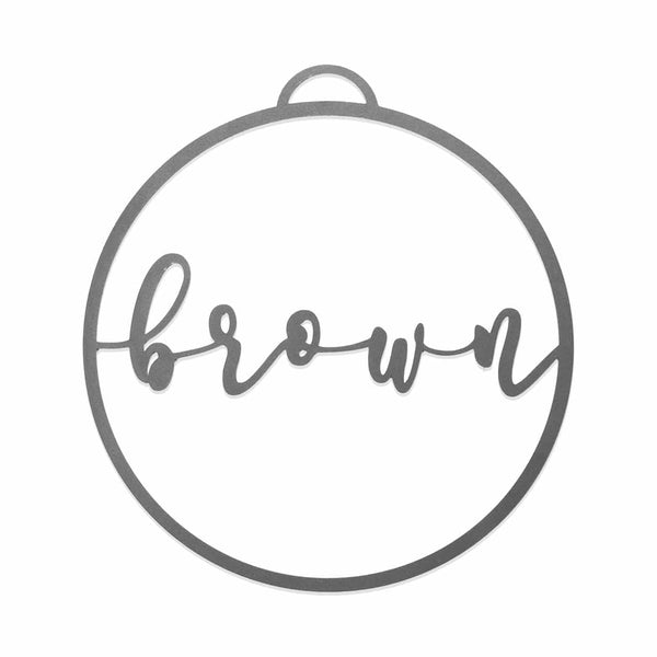 Circle metal ornament with name across center shown against white background.