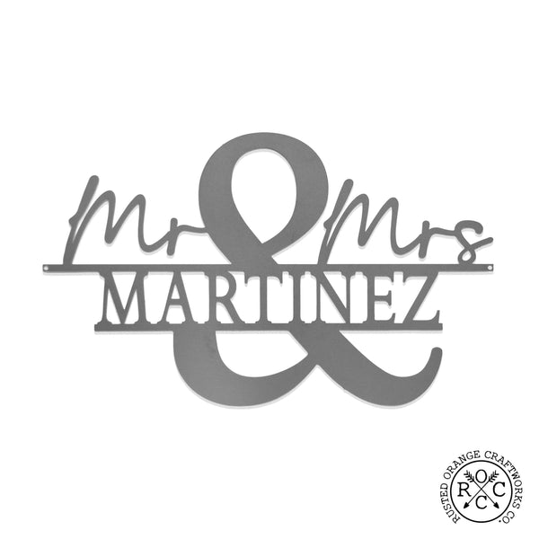 Metal personalized mr & mrs name sign shown against white background.