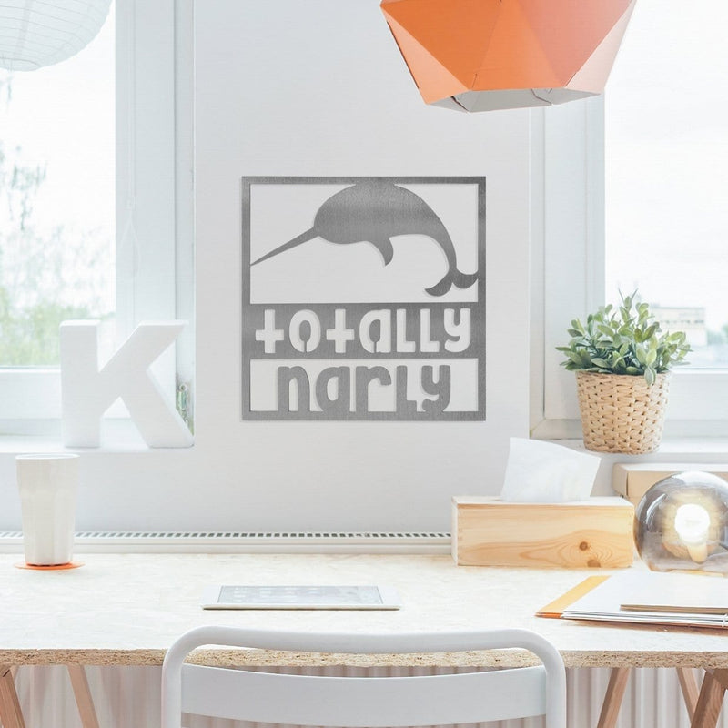 Narwhal sign on wall above desk