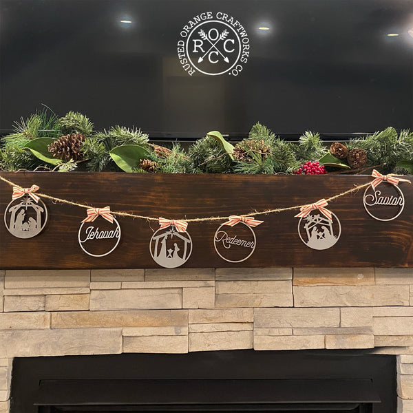 nativity ornaments on rope above fireplace