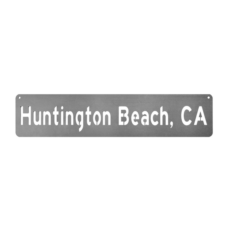 Rectangle metal sign with location name shown against white background.