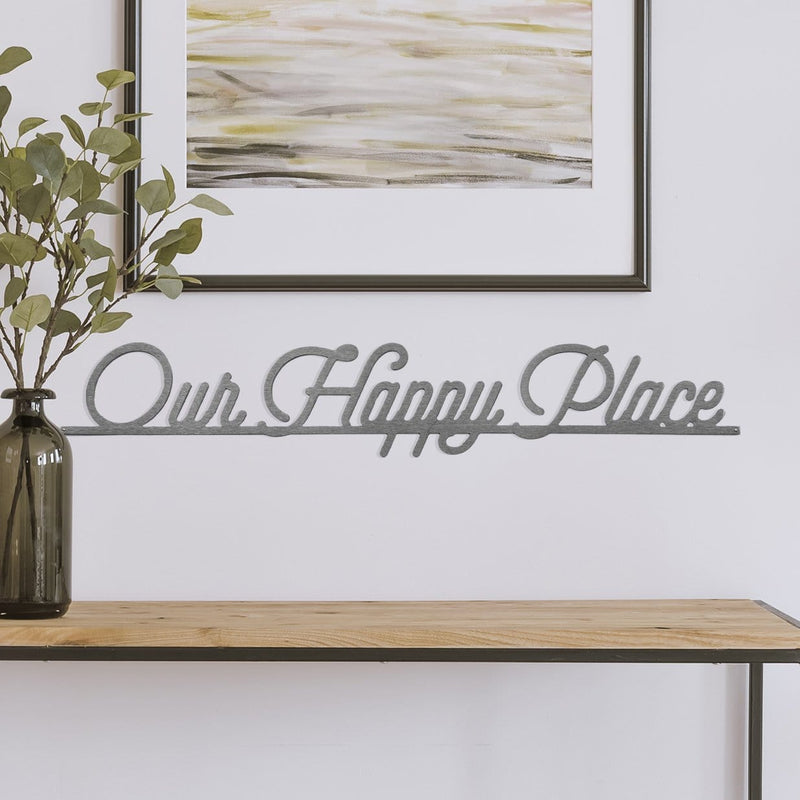 our happy place phrase sign on wall