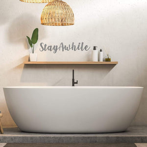 stay awhile sign on wall above bed