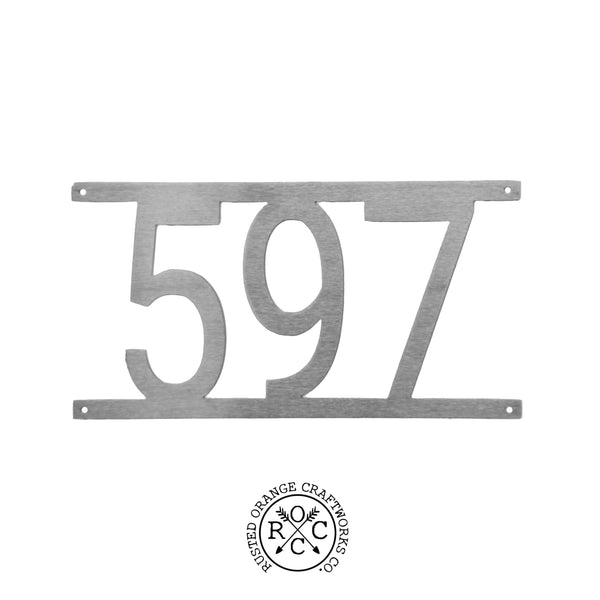 Custom metal house number shown against white background.