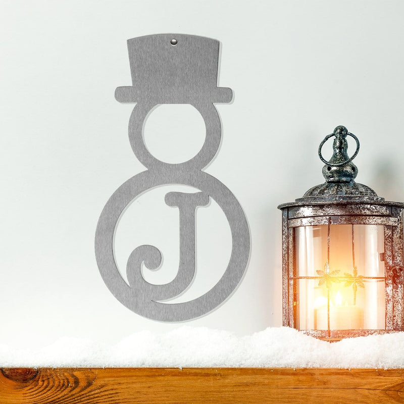 snowman monogram on wall above mantle