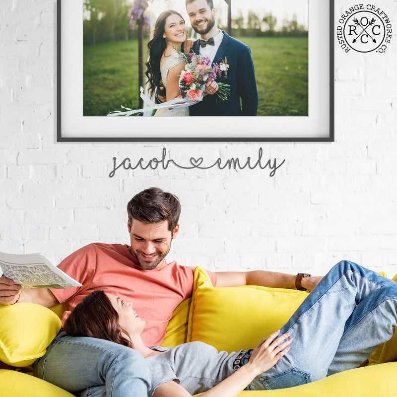 I heart you sign above couple on couch