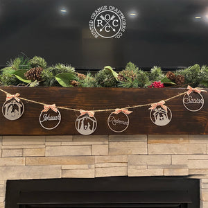 nativity ornaments on rope above fireplace