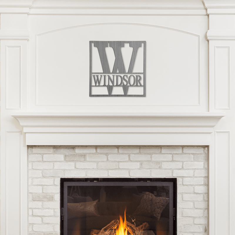 monogram sign on wall above fireplace