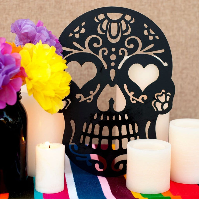sugar skull on table with candles