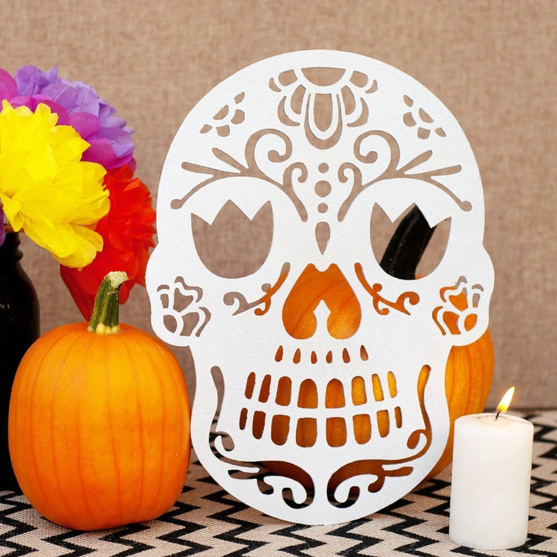 Sugar skull on table with pumpkins 