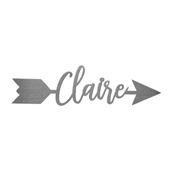 Metal arrow with name etched in center shown against white background.
