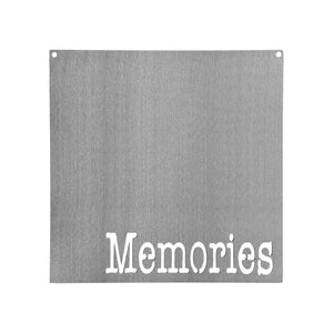 Square metal magnet board with the word memories etched at the bottom.