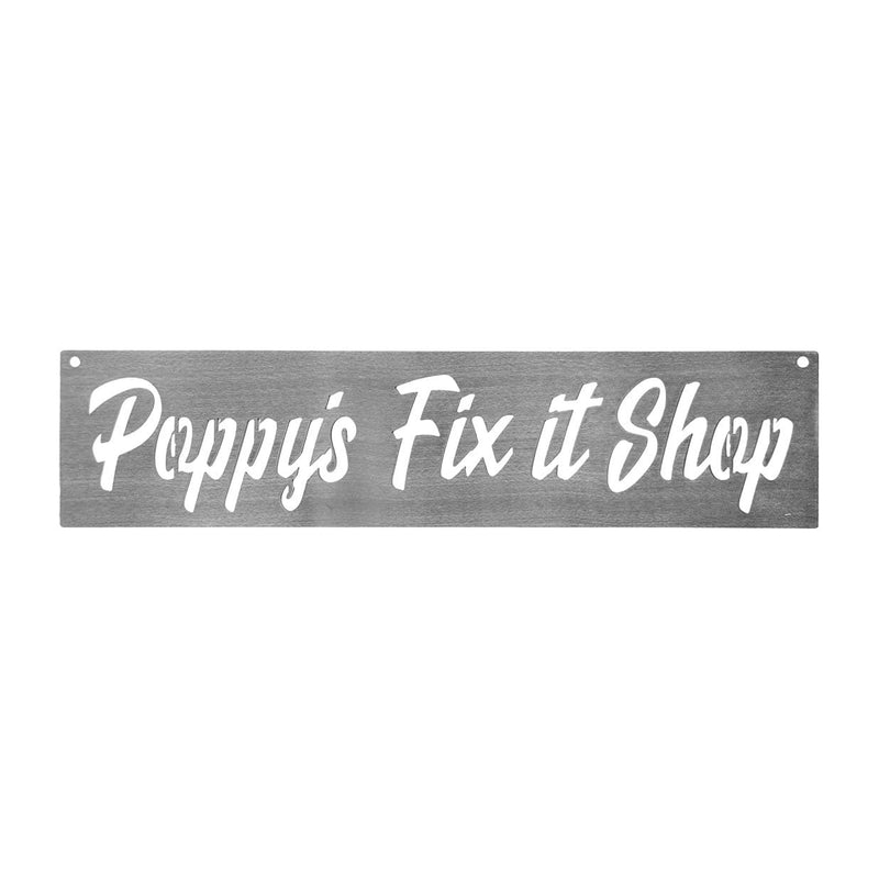 Rectangle metal sign saying Poppy's Fix it Shop shown against white background.