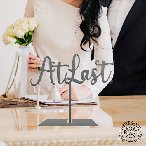 at last sign on table by guest book