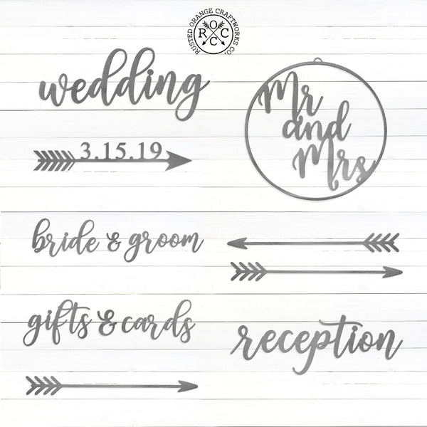 Various metal signs and decorations for wedding against white background.