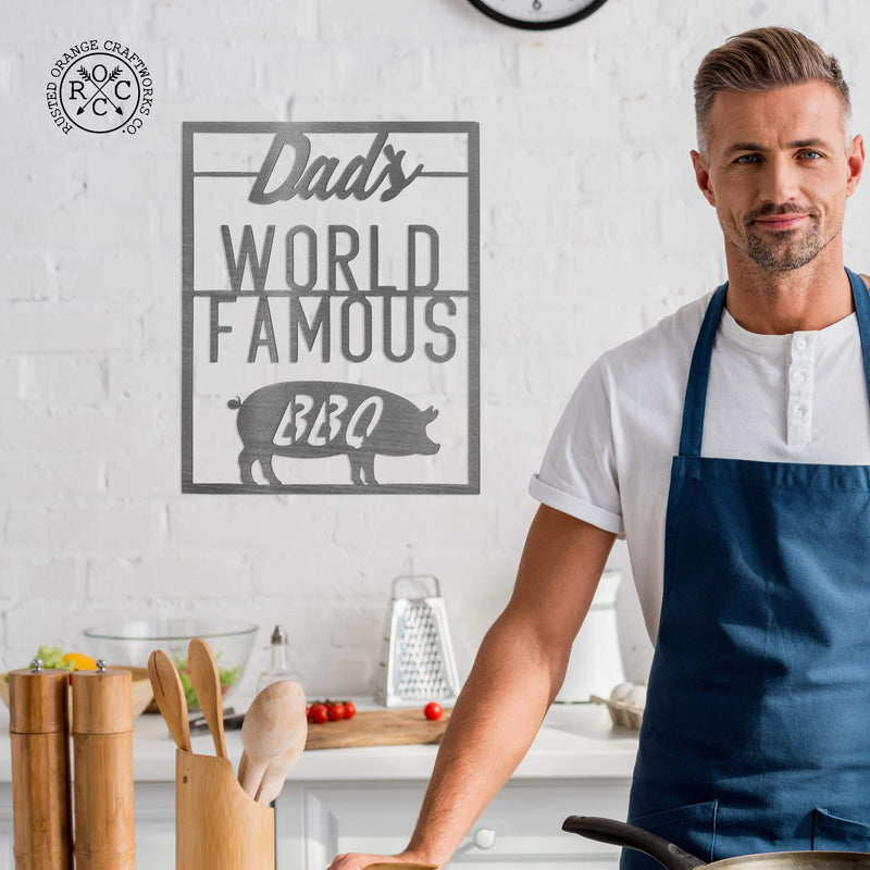 world famous bbq sign on wall behind man in apron