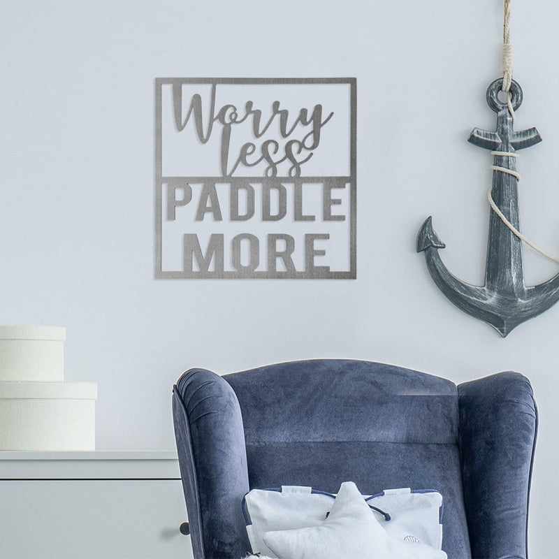 Worry less paddle more sign on wall